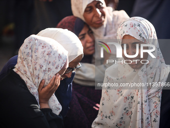 Palestinians are mourning over the bodies of loved ones following Israeli bombardment in Deir el-Balah in the central Gaza Strip on July 10,...