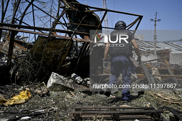 A rescue worker is looking at the damage from the July 8 Russian missile attack in Vilniansk, Zaporizhzhia region, southeastern Ukraine, on...