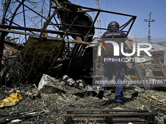 A rescue worker is looking at the damage from the July 8 Russian missile attack in Vilniansk, Zaporizhzhia region, southeastern Ukraine, on...