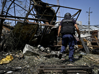 A rescue worker is looking at the damage from the July 8 Russian missile attack in Vilniansk, Zaporizhzhia region, southeastern Ukraine, on...