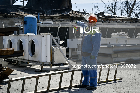 A man is pointing at a building damaged by the July 8 Russian missile attack in Vilniansk, Zaporizhzhia region, southeastern Ukraine, on Jul...