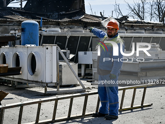 A man is pointing at a building damaged by the July 8 Russian missile attack in Vilniansk, Zaporizhzhia region, southeastern Ukraine, on Jul...