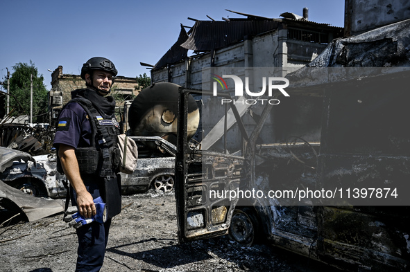 A rescue worker is looking at the damage from the July 8 Russian missile attack in Vilniansk, Zaporizhzhia region, southeastern Ukraine, on...