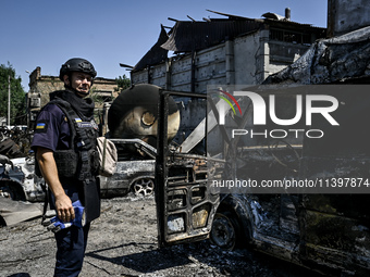 A rescue worker is looking at the damage from the July 8 Russian missile attack in Vilniansk, Zaporizhzhia region, southeastern Ukraine, on...