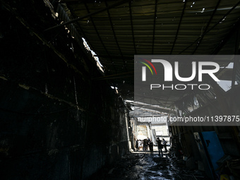 A hangar with agricultural products is being damaged by the July 8 Russian missile attack in Vilniansk, Ukraine, on July 9, 2024. NO USE RUS...