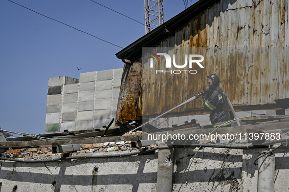 A firefighter is putting out a fire in a building damaged by the July 8 Russian missile attack in Vilniansk, Zaporizhzhia region, southeaste...