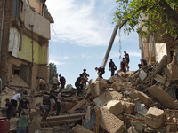 The ruins of a section of a five-storey apartment building in the Shevchenkivskyi district are being dismantled after the Russian missile at...