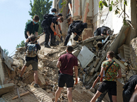 The ruins of a section of a five-storey apartment building in the Shevchenkivskyi district are being dismantled after the Russian missile at...