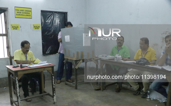 A man is casting his ballot at a polling station during the by-election in the Maniktala constituency in Kolkata, India, on July 10, 2024. 