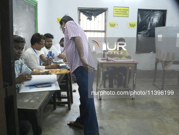 A man is casting his ballot at a polling station during the by-election in the Maniktala constituency in Kolkata, India, on July 10, 2024. 