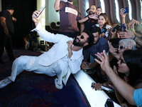 Bollywood actor Vicky Kaushal is taking a selfie with his fans during their upcoming movie 'Bad Newz' promotional event in Jaipur, Rajasthan...