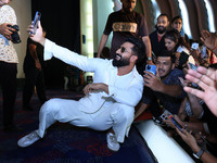 Bollywood actor Vicky Kaushal is taking a selfie with his fans during their upcoming movie 'Bad Newz' promotional event in Jaipur, Rajasthan...