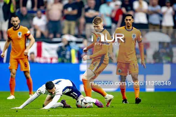 England midfielder Phil Foden and Netherlands midfielder Jerdy Schouten are playing during the match between Netherlands and England at the...