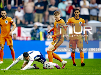 England midfielder Phil Foden and Netherlands midfielder Jerdy Schouten are playing during the match between Netherlands and England at the...