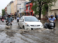 Commuters are wading through a waterlogged road during the monsoon rain in Jaipur, Rajasthan, India, on July 10, 2024. (