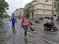 Commuters are wading through a waterlogged road during the monsoon rain in Jaipur, Rajasthan, India, on July 10, 2024. (