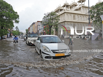 Commuters are wading through a waterlogged road during the monsoon rain in Jaipur, Rajasthan, India, on July 10, 2024. (