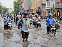 Commuters are wading through a waterlogged road during the monsoon rain in Jaipur, Rajasthan, India, on July 10, 2024. (