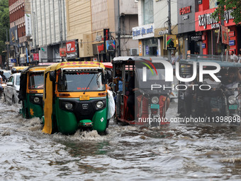 Commuters are wading through a waterlogged road during the monsoon rain in Jaipur, Rajasthan, India, on July 10, 2024. (