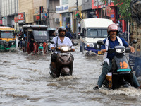 Commuters are wading through a waterlogged road during the monsoon rain in Jaipur, Rajasthan, India, on July 10, 2024. (