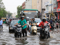 Commuters are wading through a waterlogged road during the monsoon rain in Jaipur, Rajasthan, India, on July 10, 2024. (