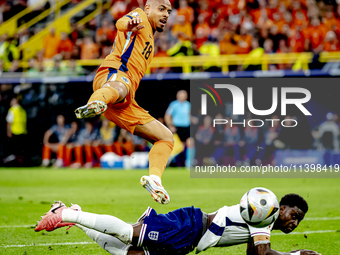 Netherlands forward Donyell Malen is playing against England defender Marc Guehi during the match between the Netherlands and England at the...