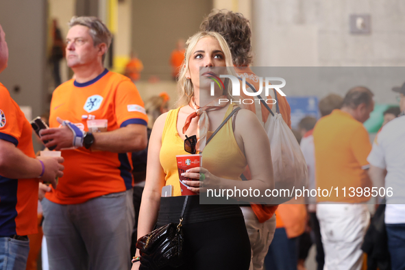 Fans are hiding from the rain before the Semi Final of the UEFA European Championship between England and Netherlands at the BVB Stadion in...