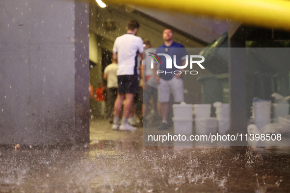 Fans are hiding from the rain before the Semi Final of the UEFA European Championship between England and Netherlands at the BVB Stadion in...