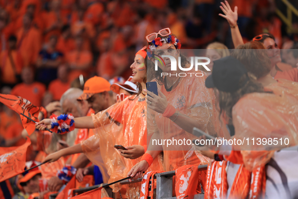 Fans are hiding from the rain before the Semi Final of the UEFA European Championship between England and Netherlands at the BVB Stadion in...