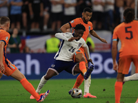 Kobbie Mainoo is being fouled during the Semi-Final of the UEFA European Championship between England and the Netherlands at the BVB Stadion...