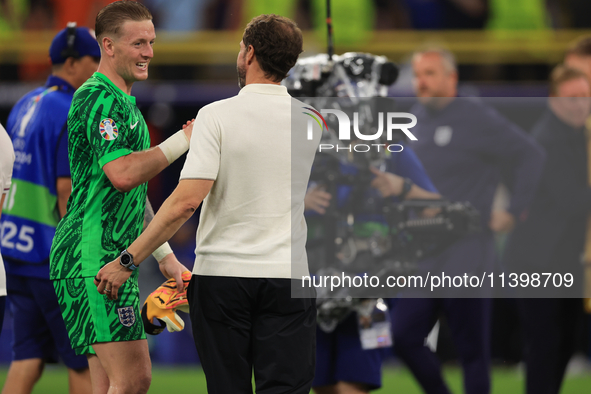 Gareth Southgate, England manager, is with Jordan Pickford (England) after the Semi Final of the UEFA European Championship between England...