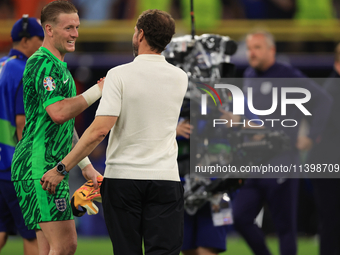 Gareth Southgate, England manager, is with Jordan Pickford (England) after the Semi Final of the UEFA European Championship between England...