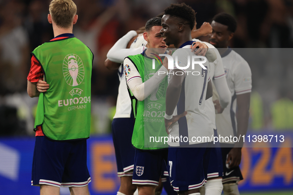 Phil Foden (England) is with Bukayo Saka (England) after the Semi Final of the UEFA European Championship between England and Netherlands in...