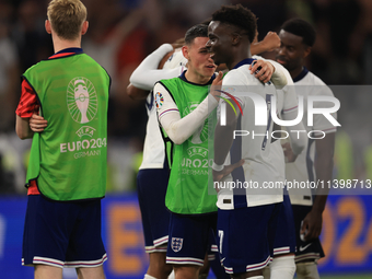 Phil Foden (England) is with Bukayo Saka (England) after the Semi Final of the UEFA European Championship between England and Netherlands in...