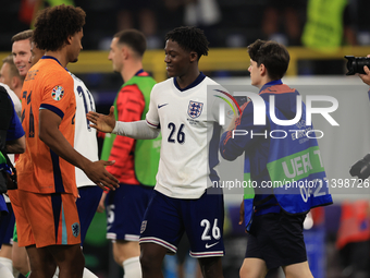 Kobbie Mainoo (England) is commiserating with Joshua Zirkzee (Netherlands) after the Semi Final of the UEFA European Championship between En...