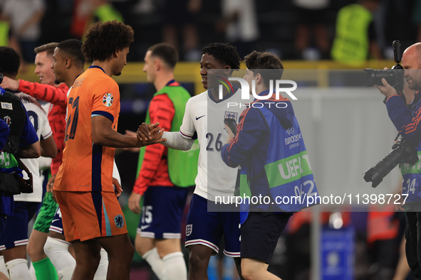 Kobbie Mainoo (England) is commiserating with Joshua Zirkzee (Netherlands) after the Semi Final of the UEFA European Championship between En...