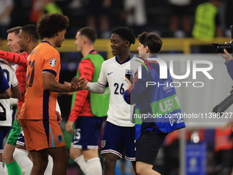 Kobbie Mainoo (England) is commiserating with Joshua Zirkzee (Netherlands) after the Semi Final of the UEFA European Championship between En...