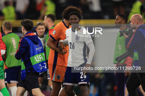 Kobbie Mainoo (England) is commiserating with Joshua Zirkzee (Netherlands) after the Semi Final of the UEFA European Championship between En...