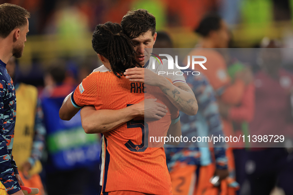 John Stones (England) is commiserating with Nathan Ake (Netherlands) after the Semi Final of the UEFA European Championship between England...