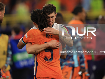 John Stones (England) is commiserating with Nathan Ake (Netherlands) after the Semi Final of the UEFA European Championship between England...