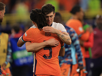 John Stones (England) is commiserating with Nathan Ake (Netherlands) after the Semi Final of the UEFA European Championship between England...