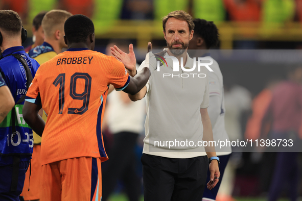 Luke Shaw (England) is commiserating with Nathan Ake (Netherlands) after the Semi Final of the UEFA European Championship between England an...