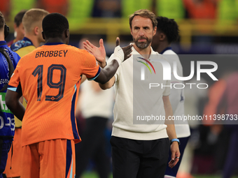 Luke Shaw (England) is commiserating with Nathan Ake (Netherlands) after the Semi Final of the UEFA European Championship between England an...