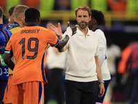 Luke Shaw (England) is commiserating with Nathan Ake (Netherlands) after the Semi Final of the UEFA European Championship between England an...