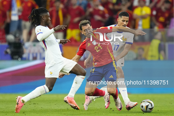 Mikel Oyarzabal centre-forward of Spain and Real Sociedad and William Saliba centre-back of France and Arsenal FC compete for the ball durin...