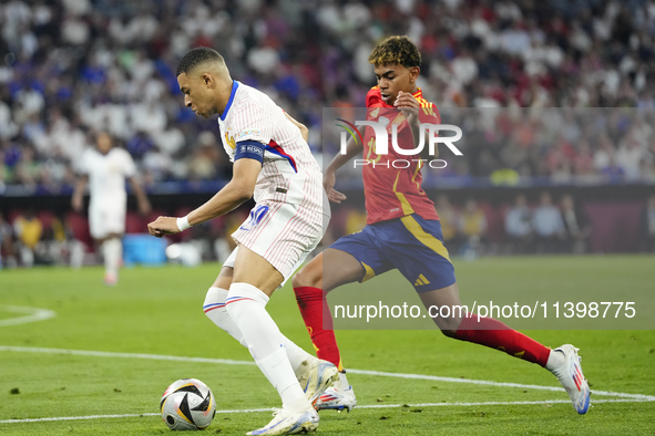 Kylian Mbappe centre-forward of France and Real Madrid and Lamine Yamal right winger of Spain and FC Barcelona during the UEFA EURO 2024 sem...