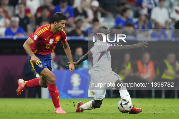 Rodrigo Hernandez defensive midfield of Spain and Manchester City and N'Golo Kante defensive midfield of France and Al-Ittihad Club compete...