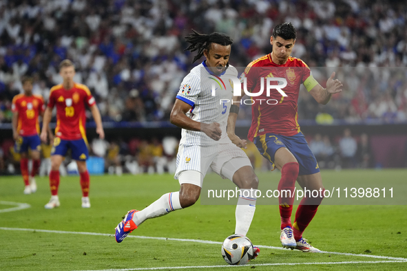 Alvaro Morata centre-forward of Spain and Atletico de Madrid and Jules Kounde centre-back of France and FC Barcelona compete for the ball du...