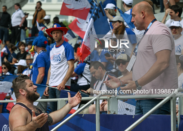 PARIS, FRANCE - JULY 08:
Piotr Malachowski (R), a Polish retired discus thrower, chatting with Pawel FAJDEK (L), during the Men's Hammer Thr...