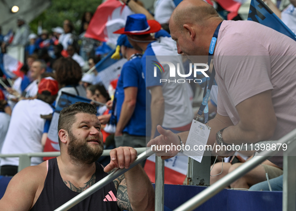 PARIS, FRANCE - JULY 08:
Piotr Malachowski (R), a Polish retired discus thrower, chatting with Pawel FAJDEK (L), during the Men's Hammer Thr...